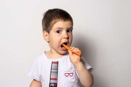 Little boy brushes his teeth with baby toothpaste. Childrens toothbrush.の写真素材