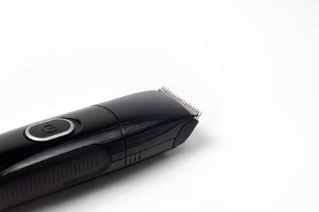 Electric black razor trimmer for shaving beards and hair shearing on a white background isolate.の写真素材