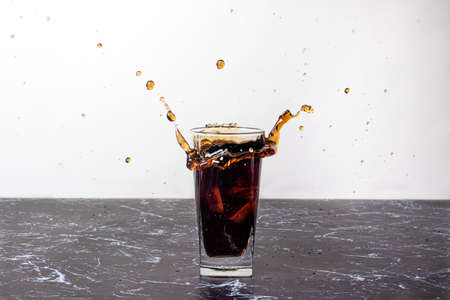 Splashing the drink. Sweet liquid spills out of a glass.の写真素材