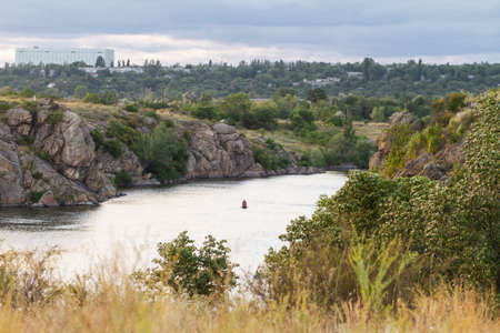 Beautiful landscape, trees, cliffs and buoys in the middle of the river. Float.