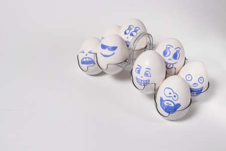 Funny chicken eggs. Smiley eggs with faces, funny faces. Eggs with emotions on a special stand.