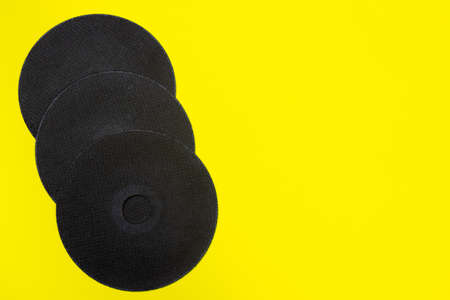 A cut-off wheel for a grinder tool on a yellow background with a place for copyspace text. Tools for...