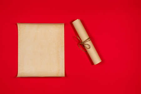 Parchment scroll for the to-do list on a red background. Glider, day planning, place for text and for entries. Copyspace. Old paper.の写真素材