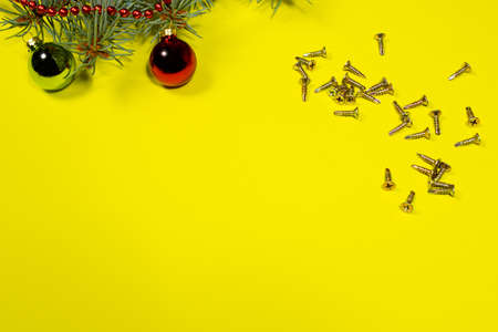 Metal self-cutters on a yellow background with a Christmas tree and a ball. New Year's banner for the workshop and building materials storeの写真素材