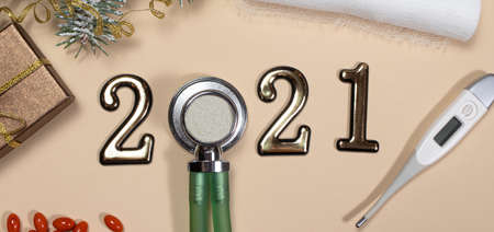 New Year's banner with figures 2021, gift and spruce branch on a beige background, year of the bull.