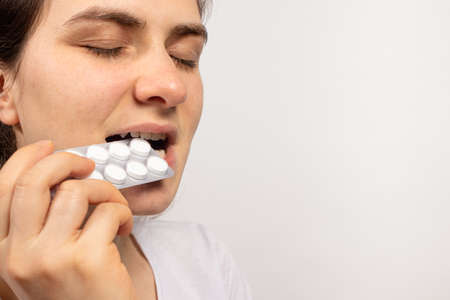 A man sprays a coughing agent into his throat - an antiseptic against laryngitis and pharyngitis....