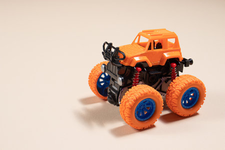 Children's toy jeep monster truck on beige background with place for text - boy's car, toy storeの写真素材