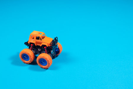 Children's toy jeep monster truck on blue background with place copy space for text - boy's car, toy store.の写真素材