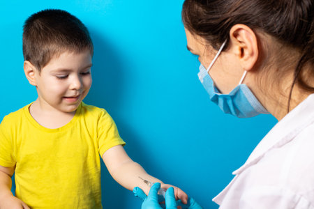 A doctor or nurse does a Mantoux test for a small baby boy. Tuberculosis test, vaccination. Intradermal tuberculin injection.の写真素材
