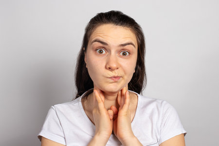 The woman probes the cervical lymph nodes - enlargement of the lymph nodes of the neck, inflammation...