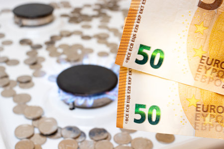 50 euro bills and a gas burner with fire. Natural gas and utilities prices in Europeの写真素材