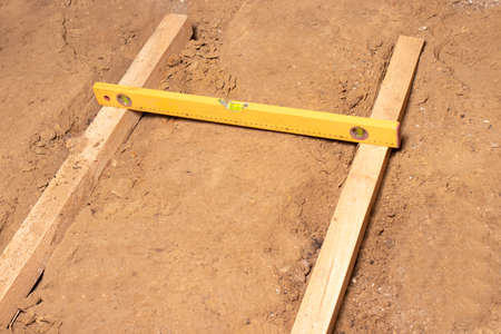 Construction bubble level at the construction site, leveling the floor. House or apartment...