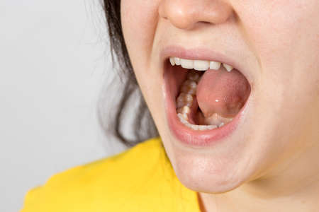 An angry aggressive woman screams with mouth open. A human cry at a child or a quarrel in the...