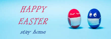 Easter eggs in protective masks on a blue background - the holiday during the epidemic and...