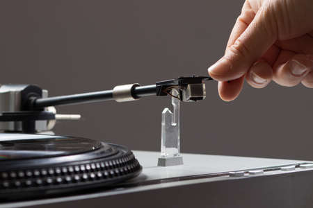 Vintage record player while recording, the record spins and music plays. Gramophone macro close-up...