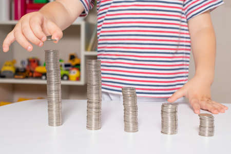 Child and coins - financial literacy for children, learning to spend moneyの写真素材