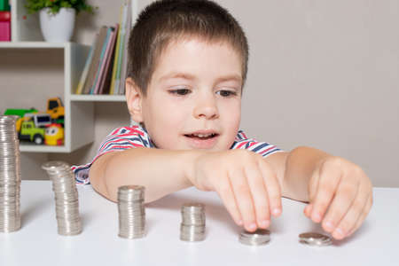 Child and coins - financial literacy for children, learning to spend moneyの写真素材