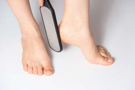 Womens feet and laser file, pedicure and foot care.の写真素材
