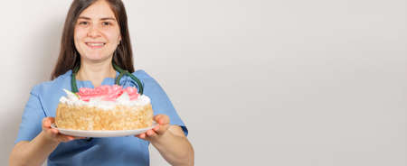 A woman holds a cake, a place for textの写真素材