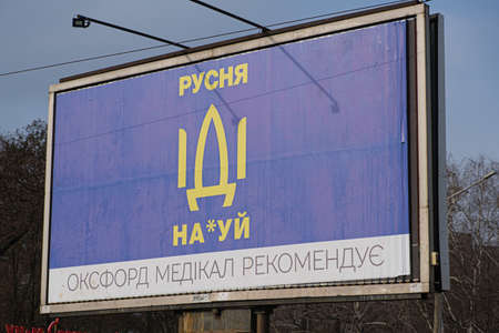 March 17, 2022, Ukraine, Zaporozhye. City banner calling for Russian soldiers to leave the territory of Ukraine. Text in Ukrainian, translation from Ukrainian: Russian Fuck you.のeditorial素材