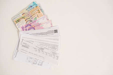 Hryvnia banknotes and payments for utilities for gas, electricity and water in Ukraine. Subsidies and benefits for the population.の写真素材
