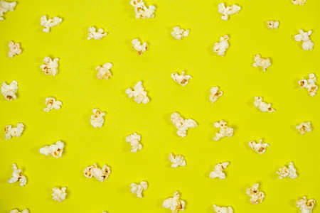 Popcorn on a yellow background, close-up view from above