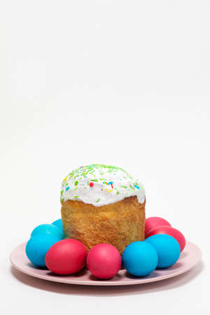 Easter cake and painted eggs on a white background, place for text, vertical card.