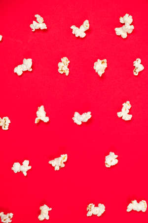 Popcorn on a red background, close-up view from above.の写真素材