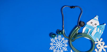 Christmas and New Year Medicine - Stethoscope, Snowmen and Snowflakes on a Blue Background, place for text.の写真素材