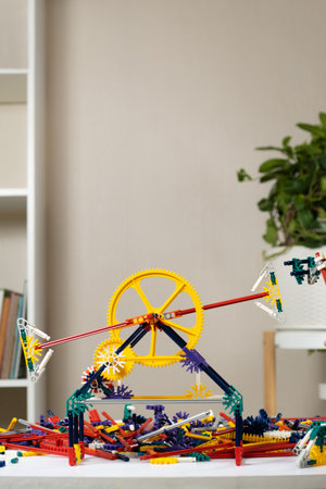 Children's constructor of gears cogwheel and sticks in the children's room. Toys for the development...