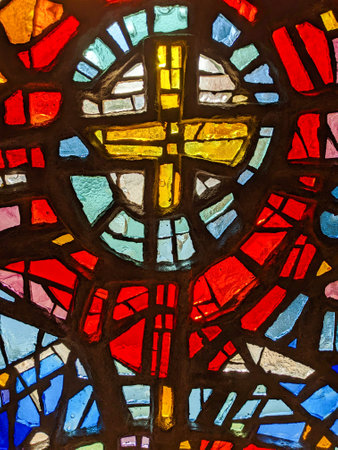 Window in the church, stained glass, colored mosaic in the form of a crossの写真素材