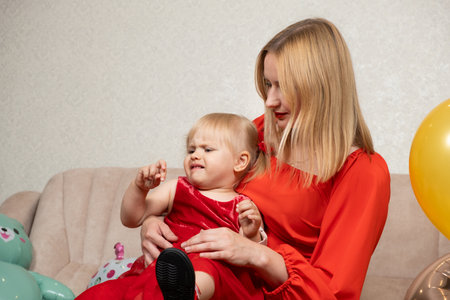 Mom and capricious two-year-old. The crisis of two years, the upbringing of children.の写真素材