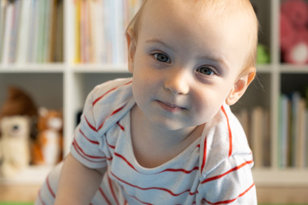 Portrait of a one-year-old baby, a blonde boy in a childrens room.の写真素材