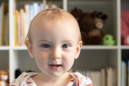 Portrait of a one-year-old baby, a blonde boy in a children's roomの写真素材