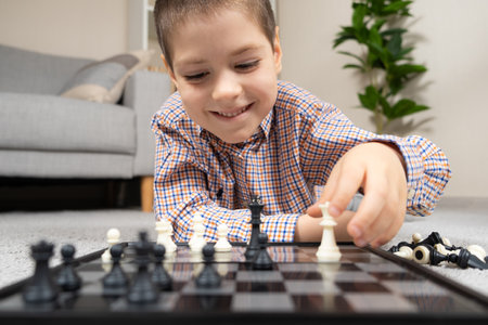 Little boy playing chess. Board games for children.の写真素材