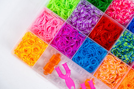 A set of multi-colored elastic bands for weaving bracelets for children