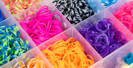 A set of multi-colored elastic bands for weaving bracelets for children