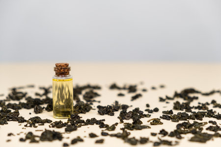Green tea oil in a glass bottle for use in cosmetology and aromatherapyの写真素材