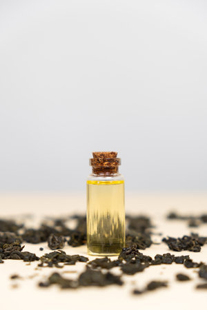 Green tea oil in a glass bottle for use in cosmetology and aromatherapyの写真素材