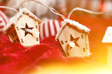 Luminous garland in the shape of wooden houses. Beautiful Christmas and New Year greeting card.の写真素材