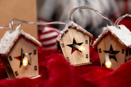 Luminous garland in the shape of wooden houses. Beautiful Christmas and New Year greeting card.の写真素材