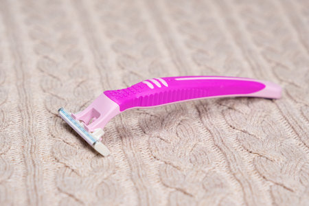 Razor on sweater. Removing pills from clothingの写真素材