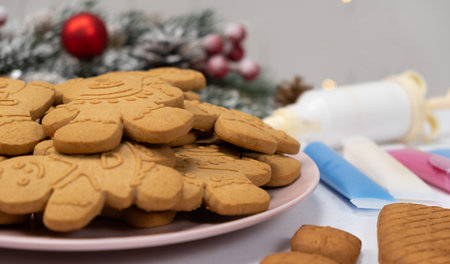 Christmas gingerbread in the shape of men and a set of colored sugar icing for decoration.