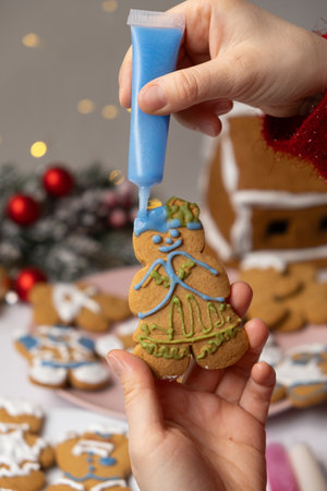 Decorating Christmas gingerbread with sugar multicolored icingの写真素材