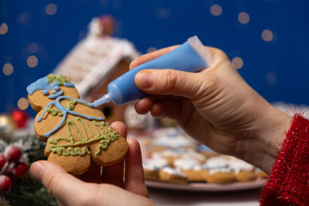 Decorating Christmas gingerbread with sugar multicolored icingの写真素材