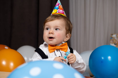 Funny one-year-old red-haired boy on his birthday