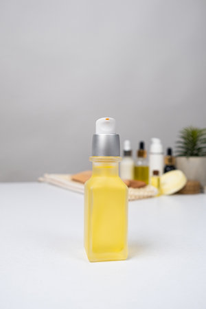Oils in cosmetology, oil in a glass jar with a dispenser for the care of the skin of the face, body and hairの写真素材