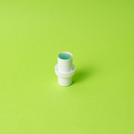 Natural liquid laundry detergent on a green background, copy space for text.