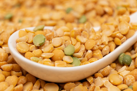 Pea yellow groats grains cereal in spoon close-up macroの写真素材