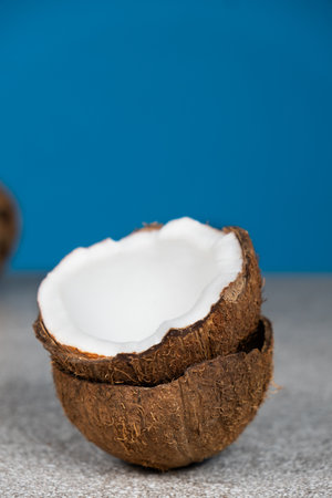 Coconuts on blue background, space for text